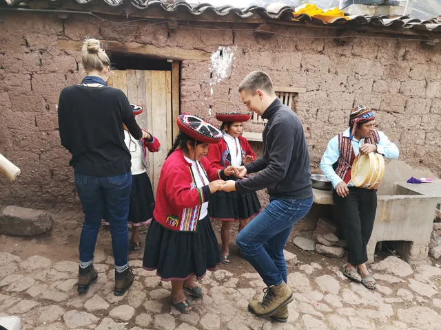 Travellers sharing a dance in an Andean community