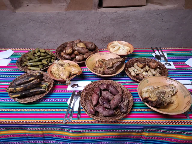 Pachamanca served on a table with Andean textiles