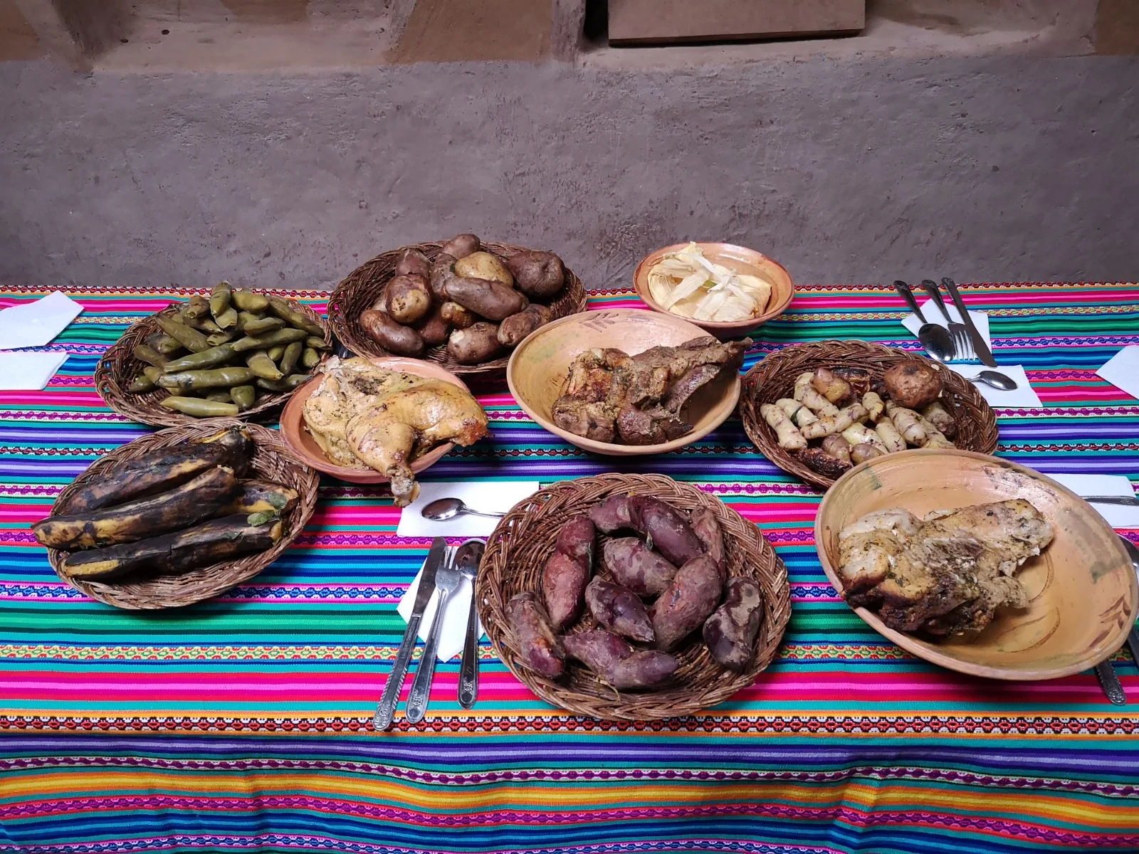 Pachamanca served on a table with Andean textiles
