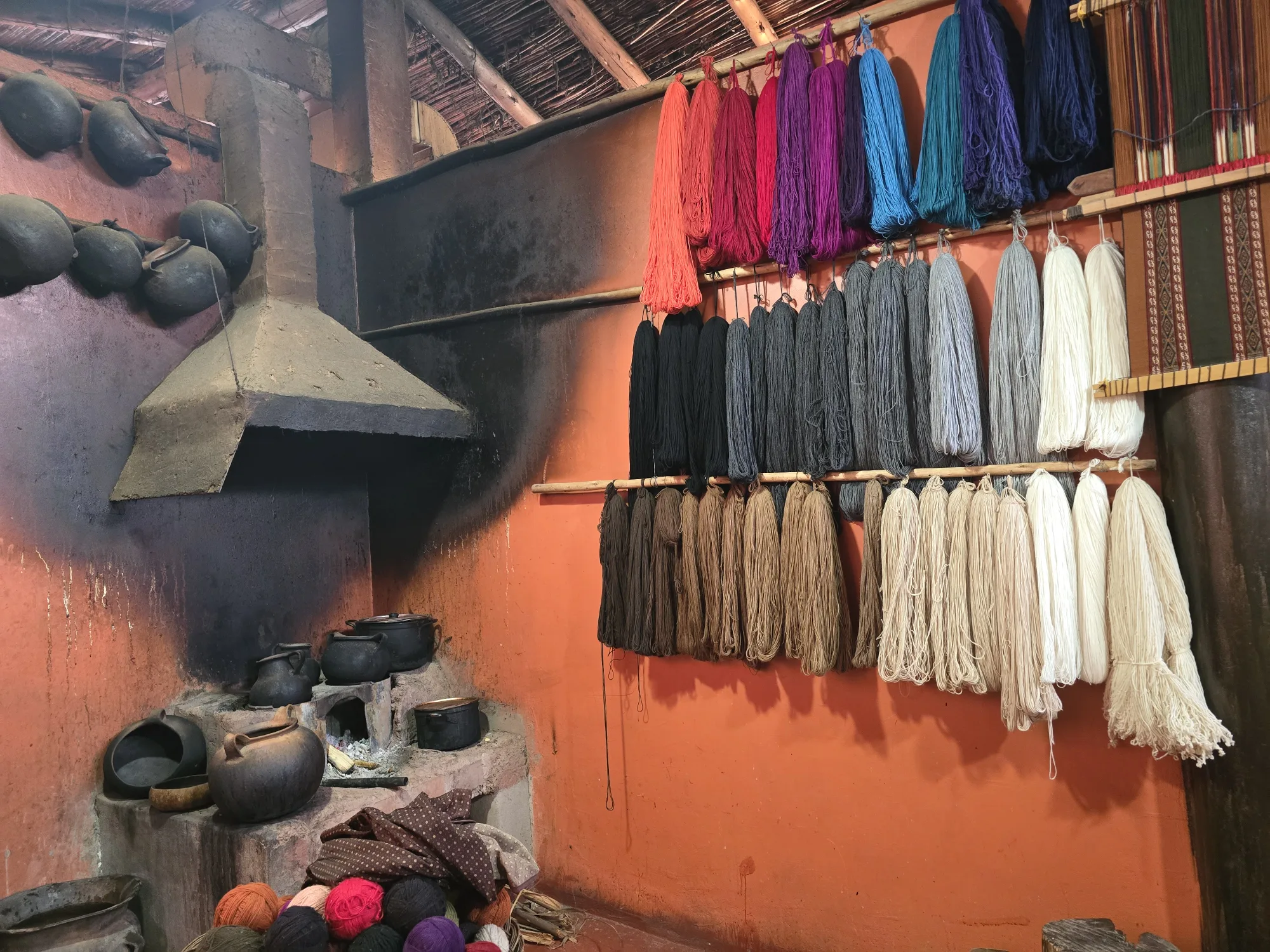 Hand-dyed wool hanging in a Chinchero workshop